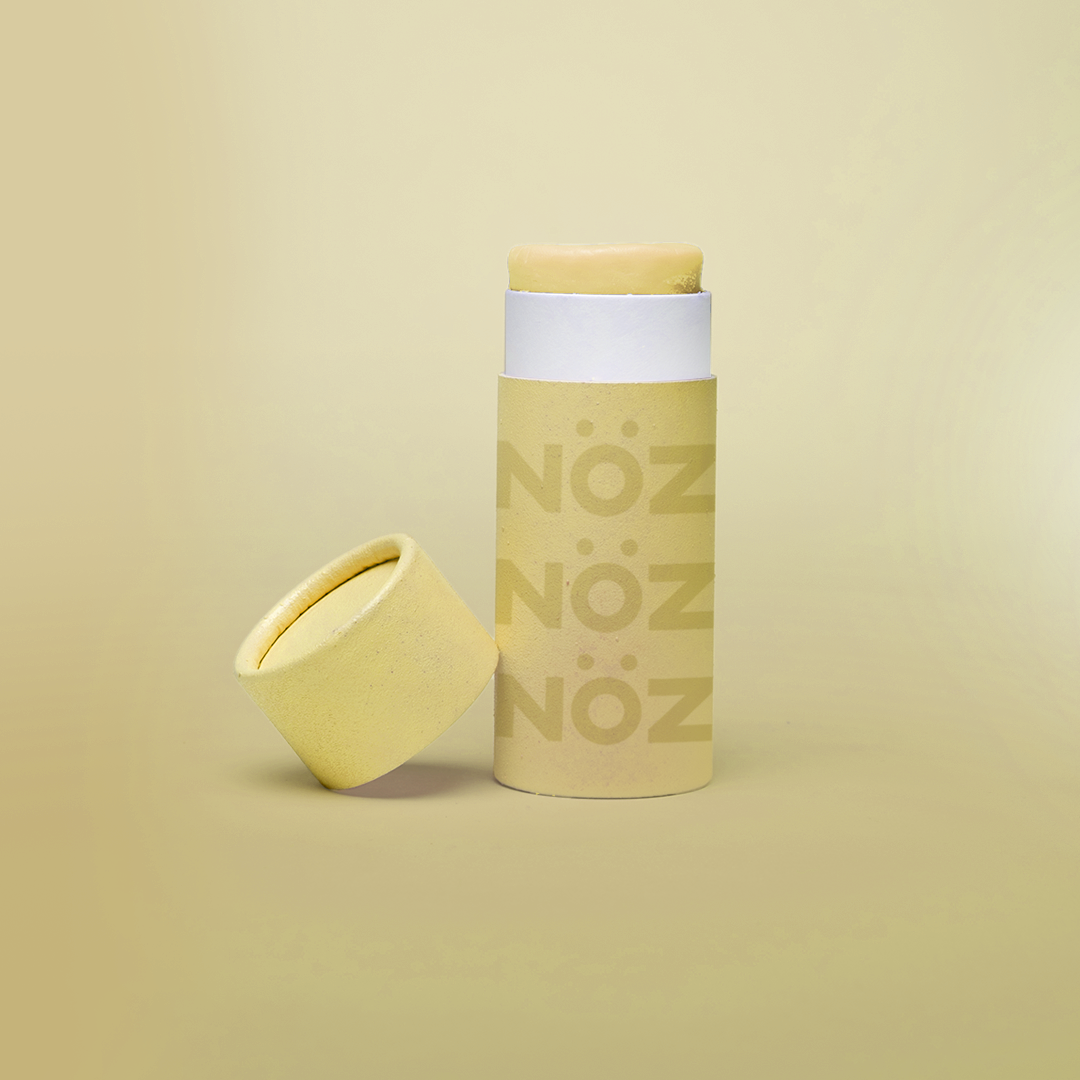 Front view of SPF15 Nöz organic sunscreen in an opened yellow colored tube.
